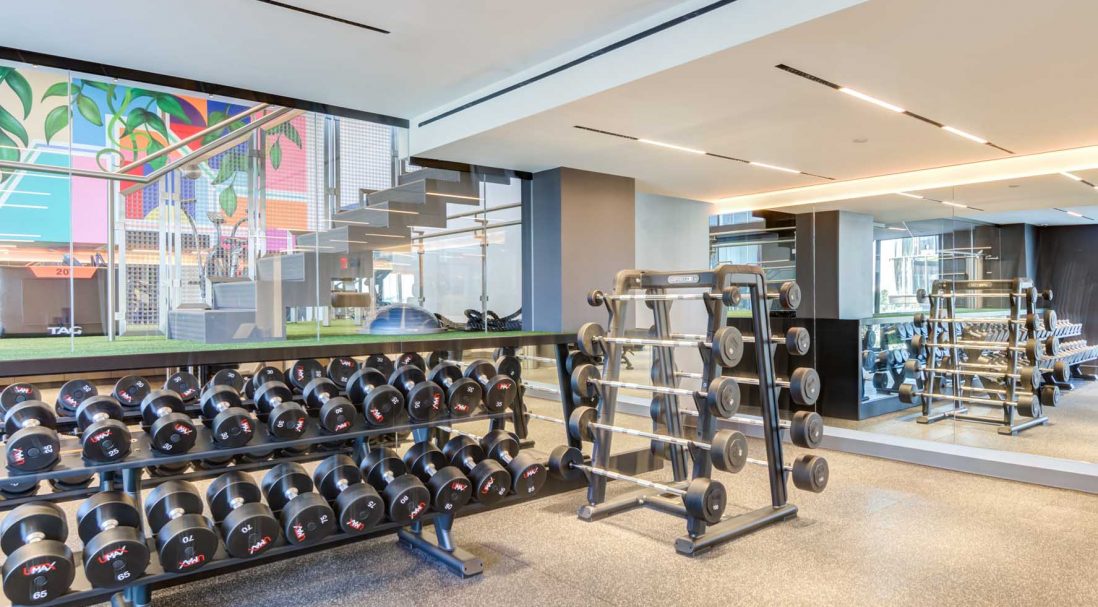 Our double-height fitness area features a custom mural to inspire your fitness goals
