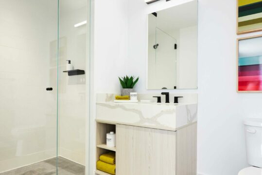 Designer fixtures in bathrooms by Kohler.